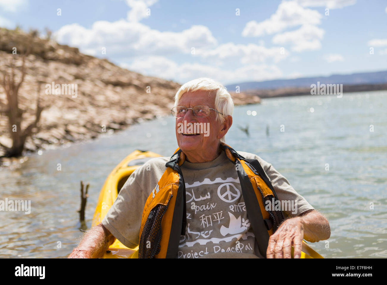 Older Caucasian man rowing on lake Stock Photo