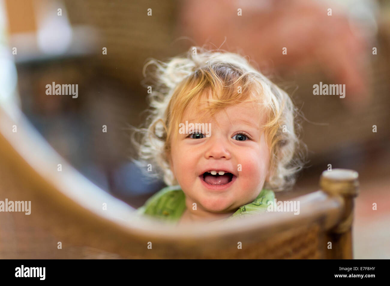 Caucasian toddler standing on chair Stock Photo
