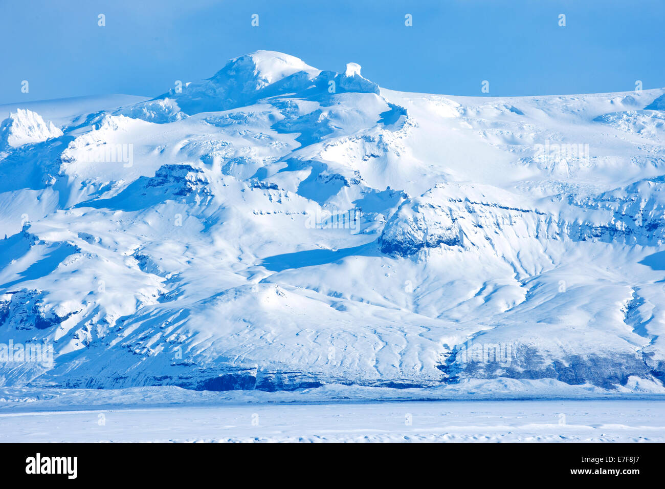 Iceberg looming over arctic landscape Stock Photo