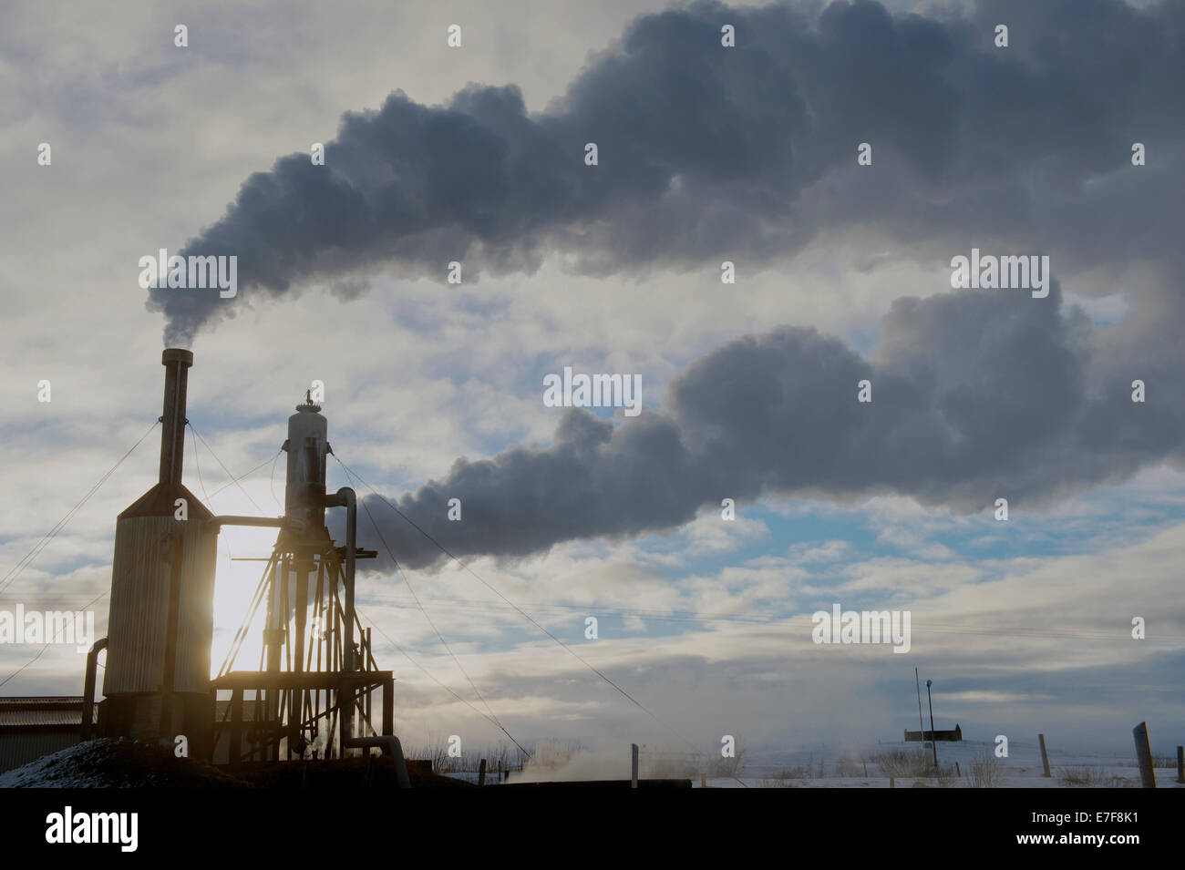 Steam billowing from power plant smoke stacks Stock Photo