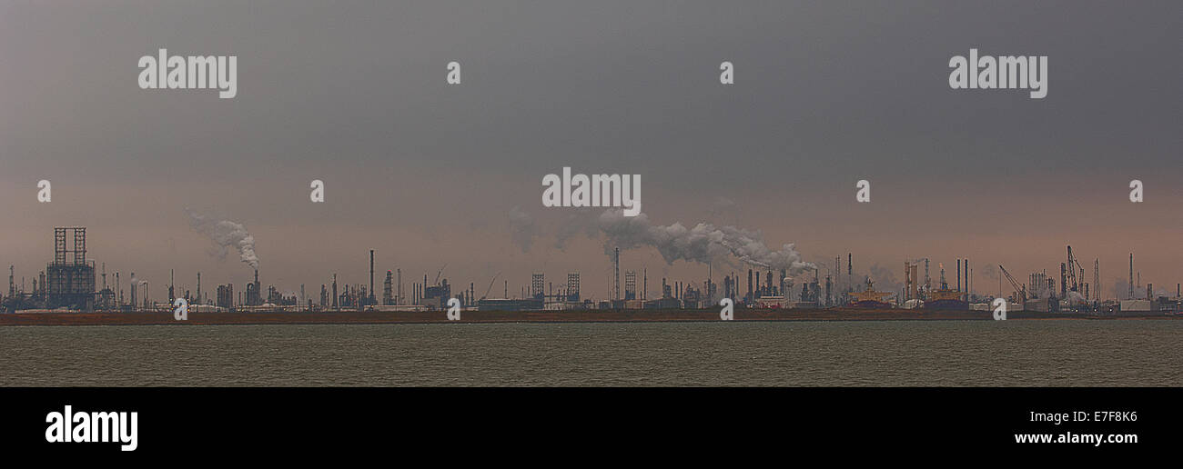 Smoke billowing from distant factory Stock Photo
