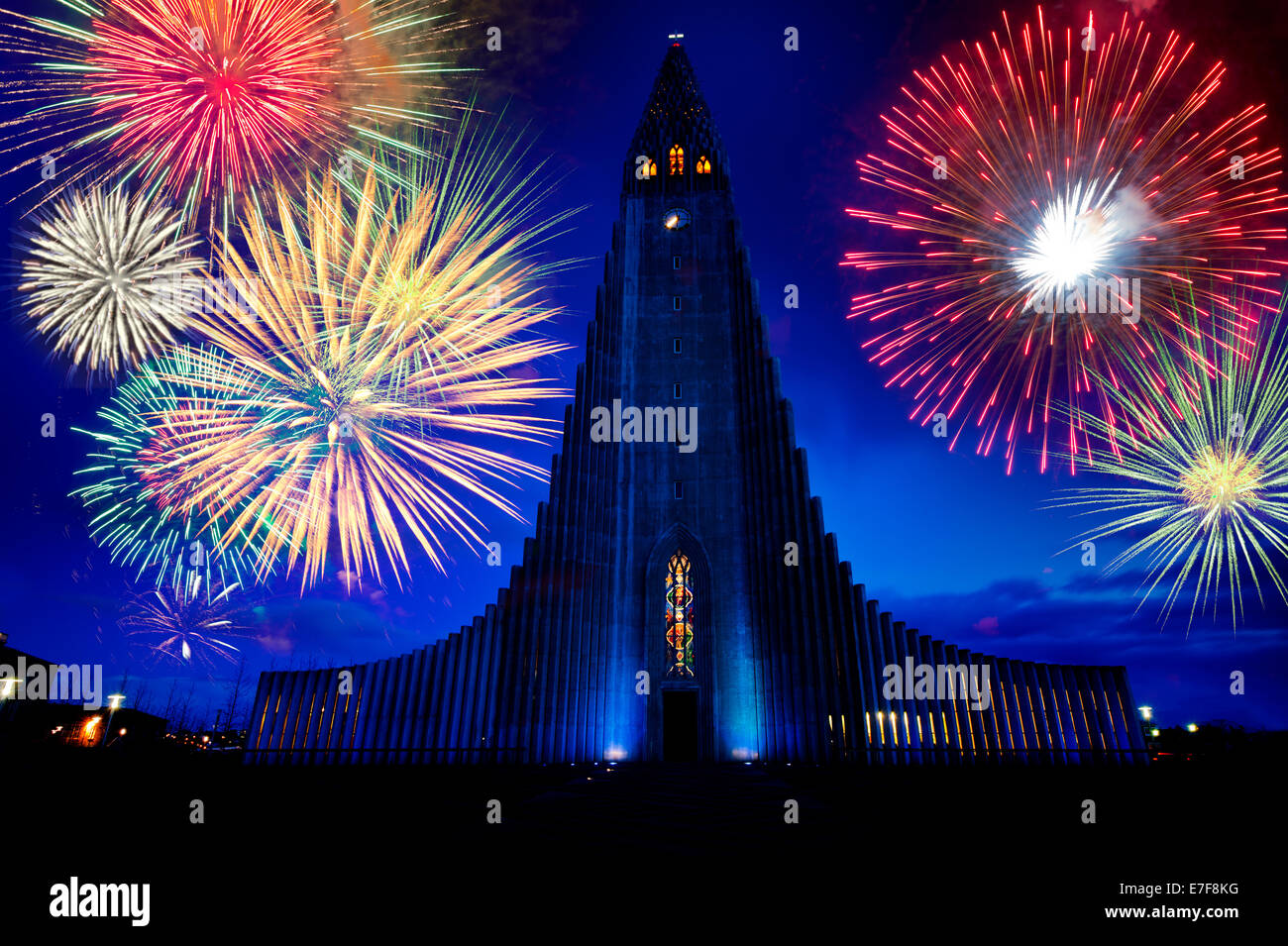 Fireworks exploding over monument in night sky, Reykjavik, Hofudborgarsvaedi, Iceland Stock Photo