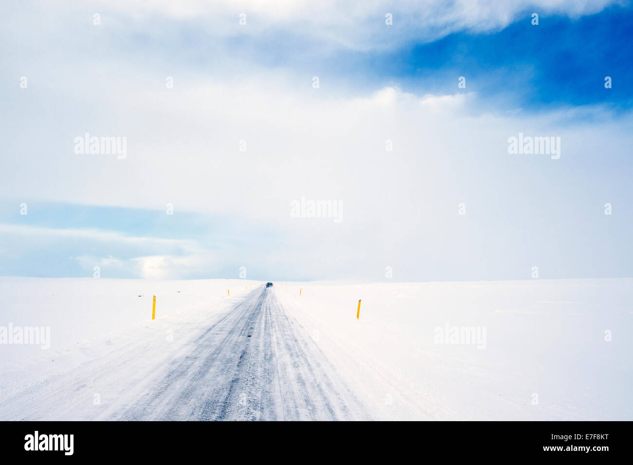 Tire tracks on rural road in snowy landscape Stock Photo
