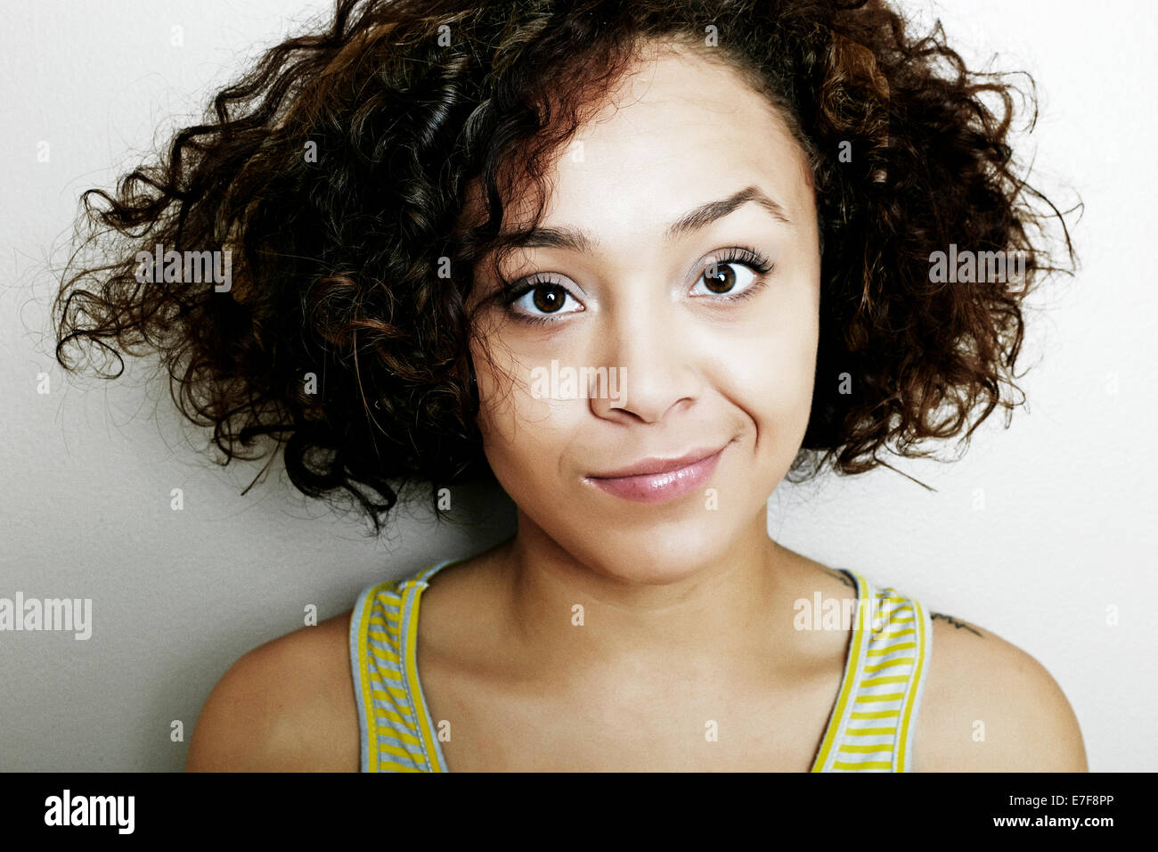 Mixed race woman smirking Stock Photo