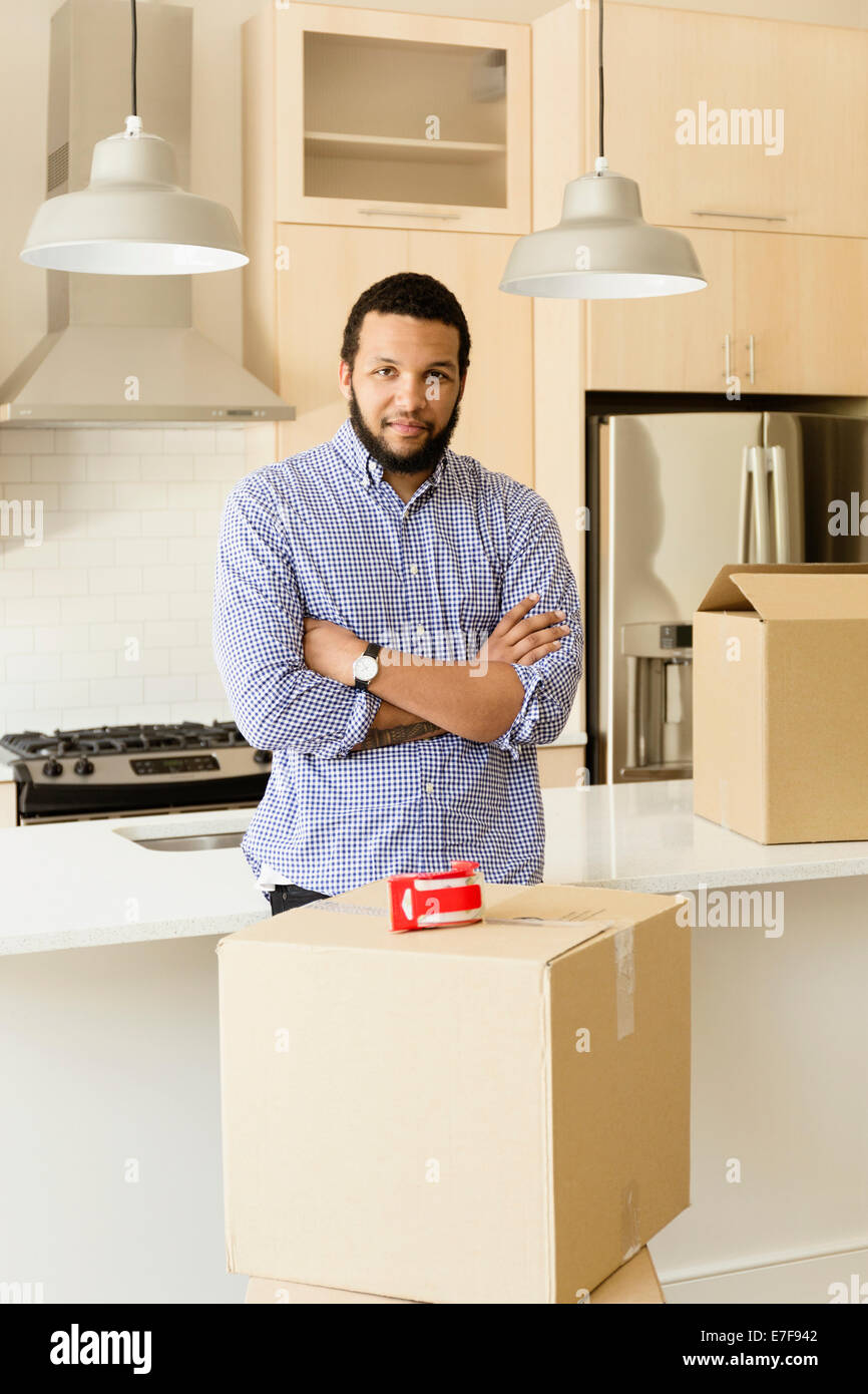 Mixed race man standing in new house Stock Photo