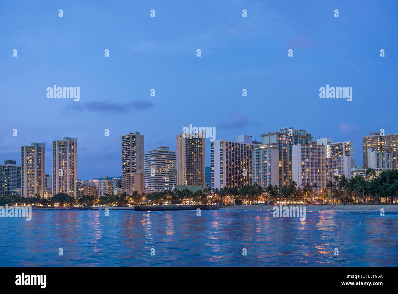 Illuminated city skyline on waterfront, Honolulu, Hawaii, United States Stock Photo