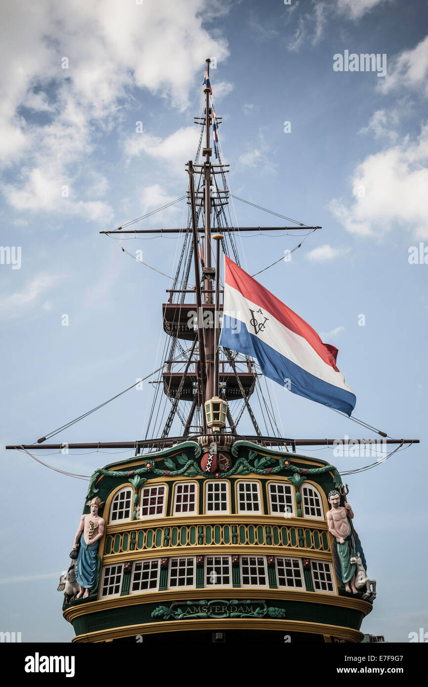 Flag flying from pirate ship against blue sky Stock Photo