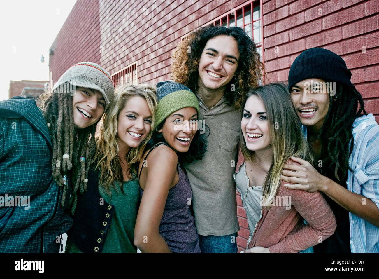 Friends smiling together on city street Stock Photo - Alamy