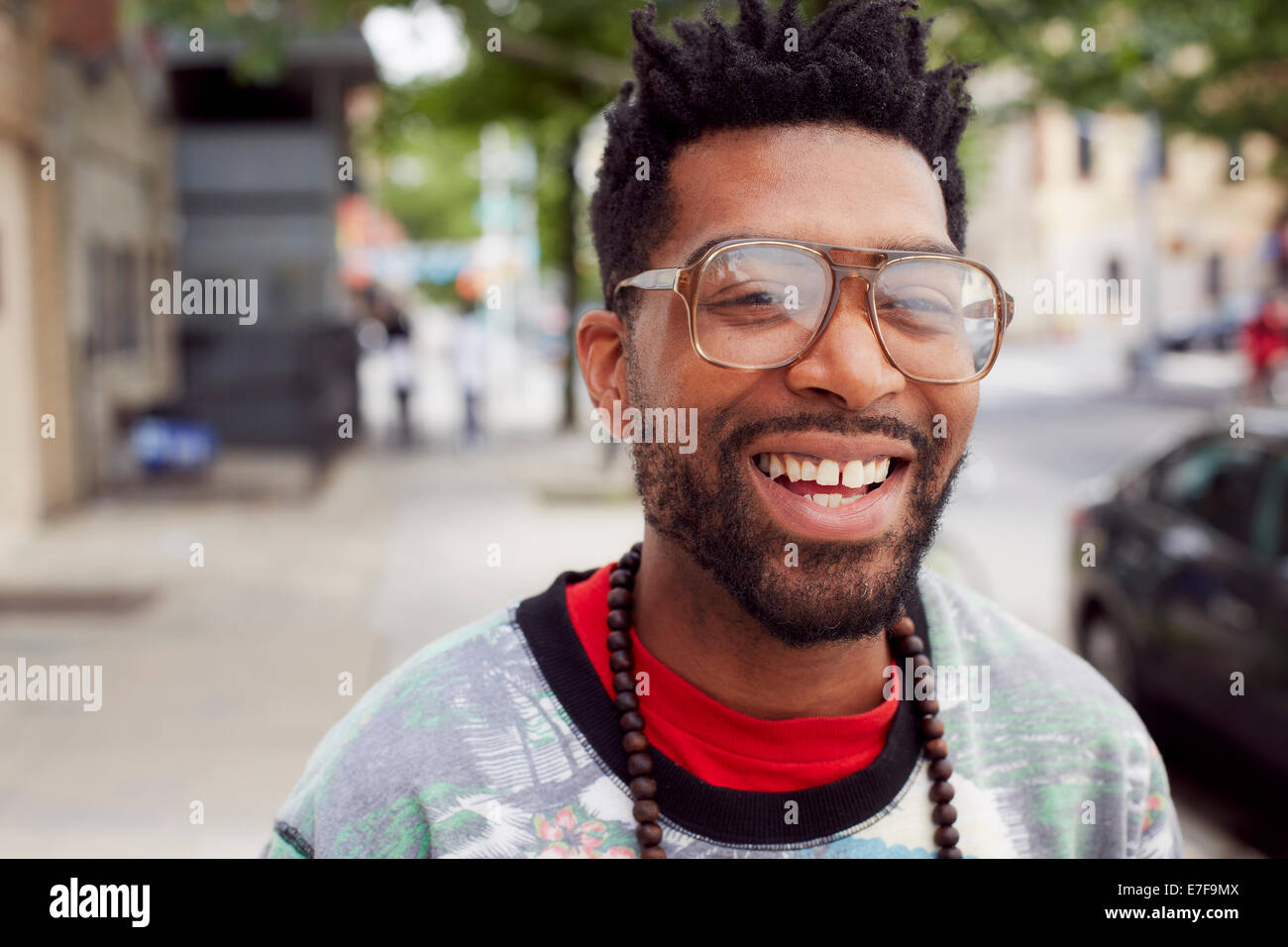 Black man smiling on city street Stock Photo