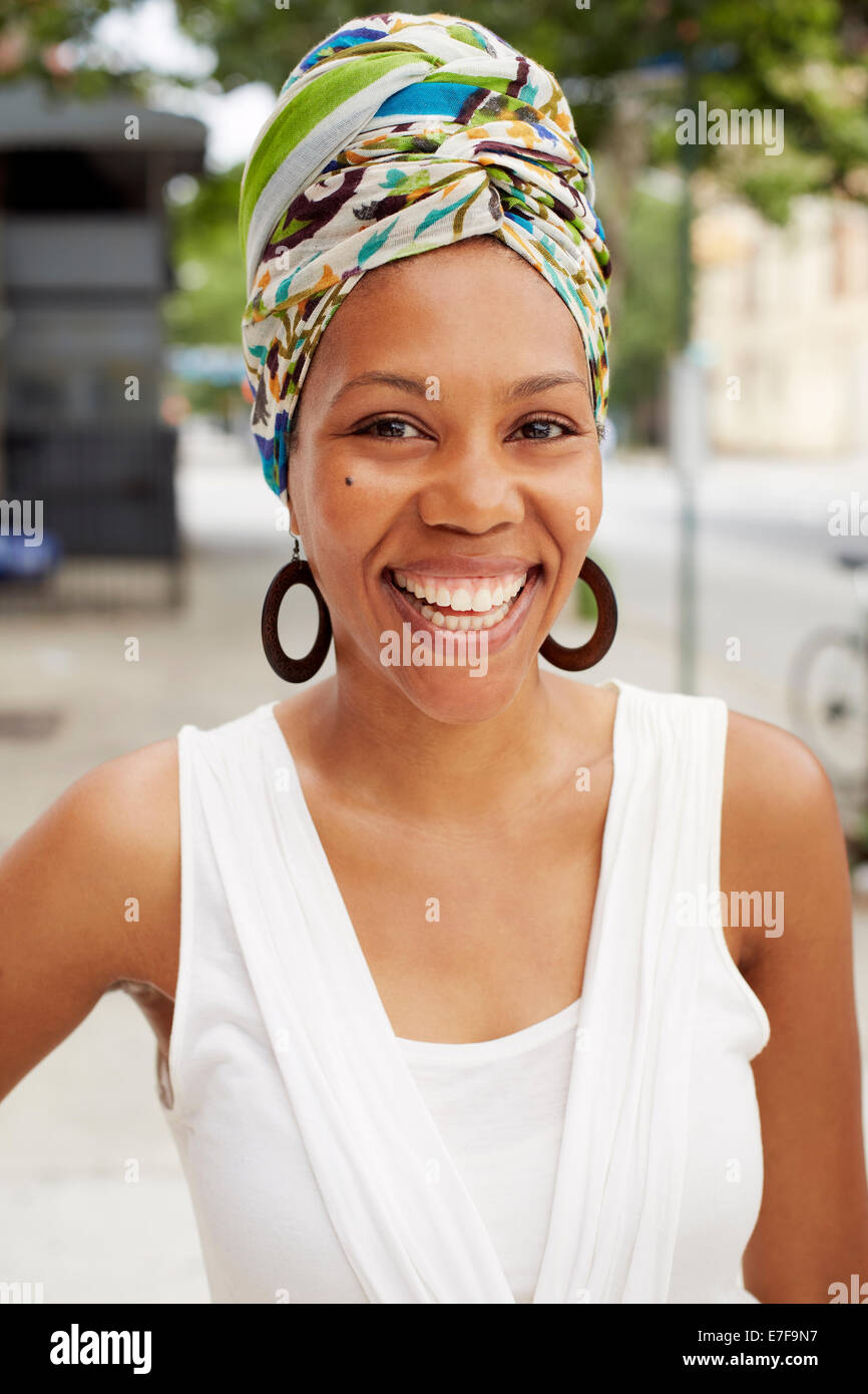 Black woman smiling on city street Stock Photo - Alamy