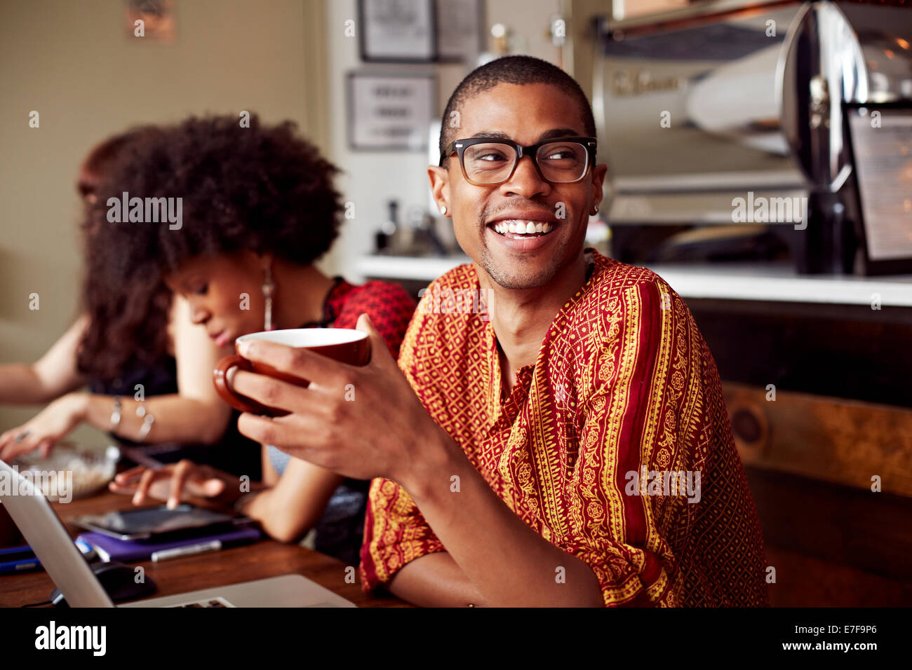 Man having cup of coffee in cafe Stock Photo Alamy