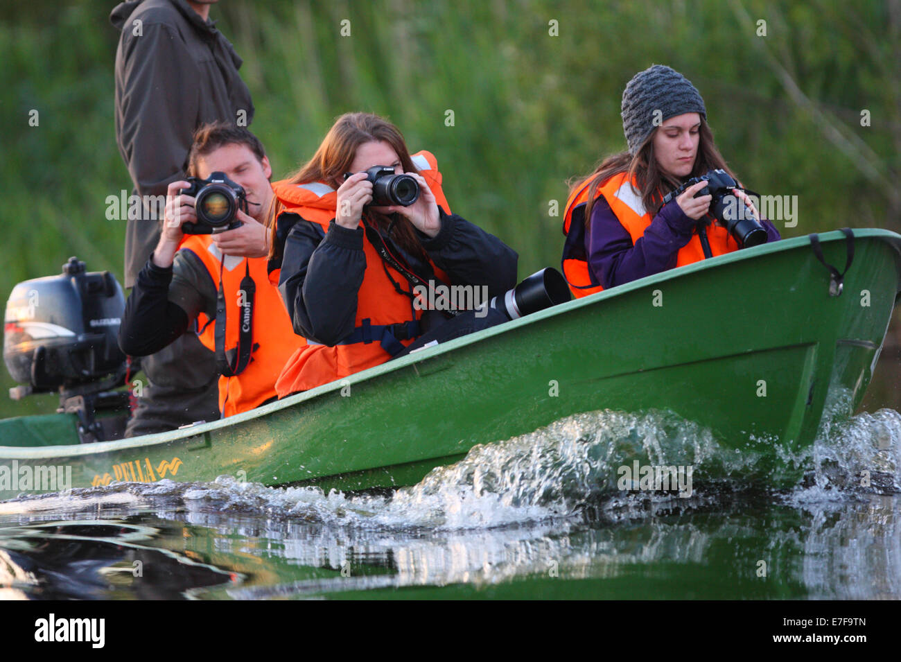 Group of wildlife photographers taking a boat ride. Europe, Estonia, Alam-Pedja Nature Reserve. Stock Photo