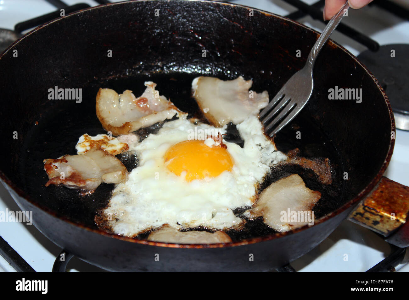 image of appetizing fried egg during cooking Stock Photo