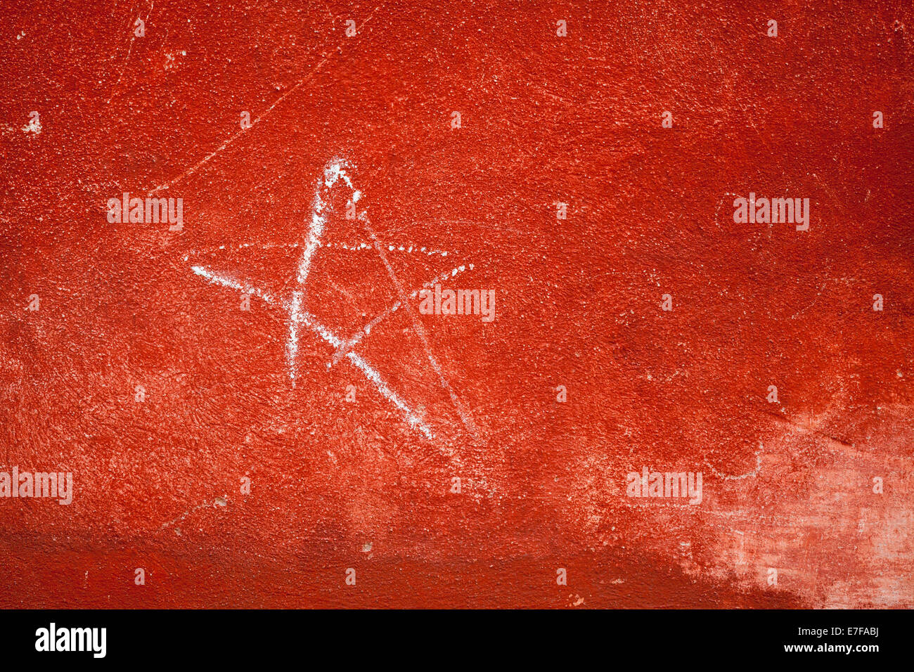 Red concrete wall with plastering and star sign Stock Photo