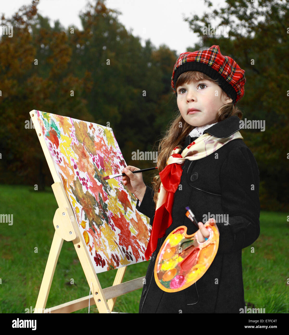Spring draws autumn. Genre portrait of young girl painter outdoors Stock Photo
