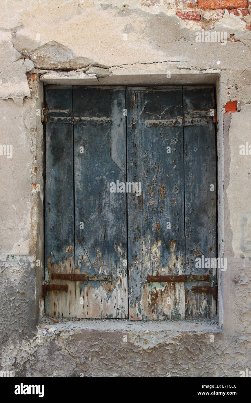 Old scratched wooden doors on grunge wall Stock Photo Alamy
