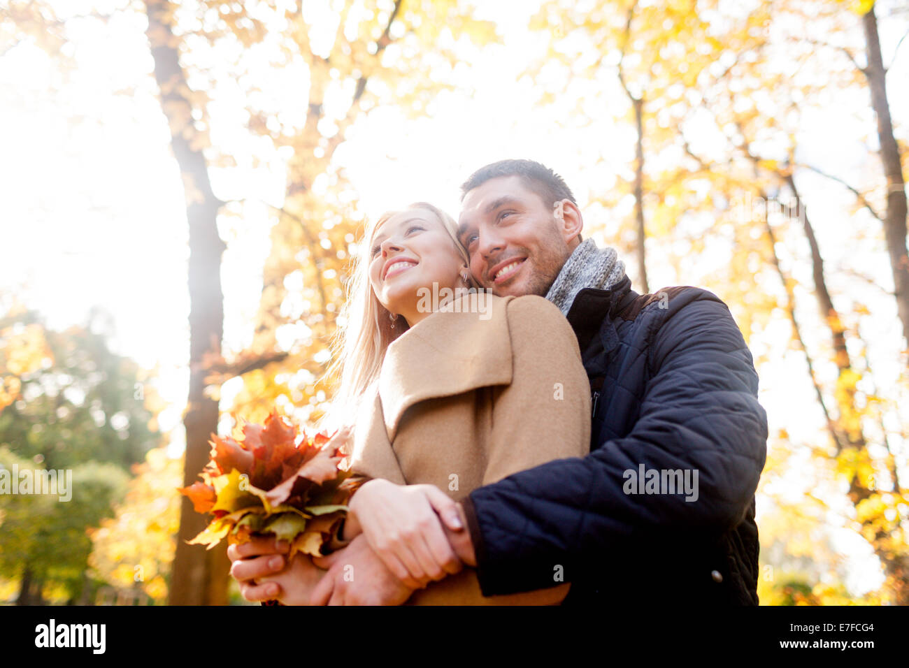 smiling couple hugging in autumn park Stock Photo - Alamy