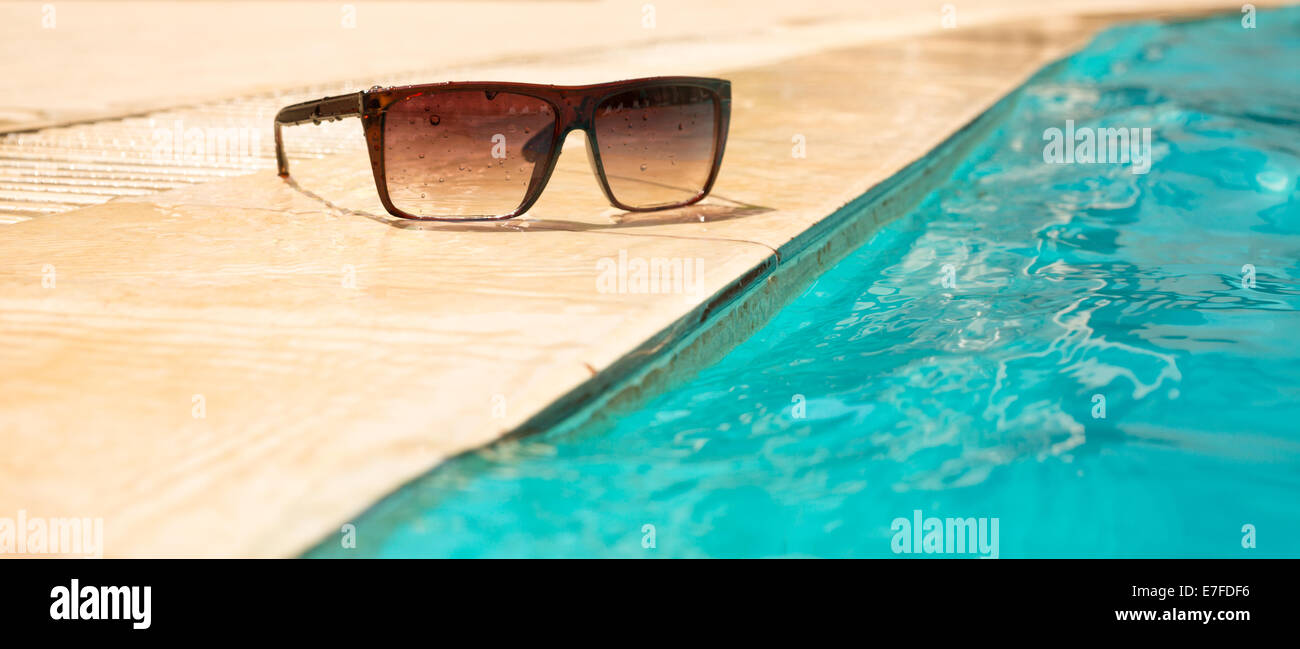 Sunglasses by the pool Stock Photo Alamy