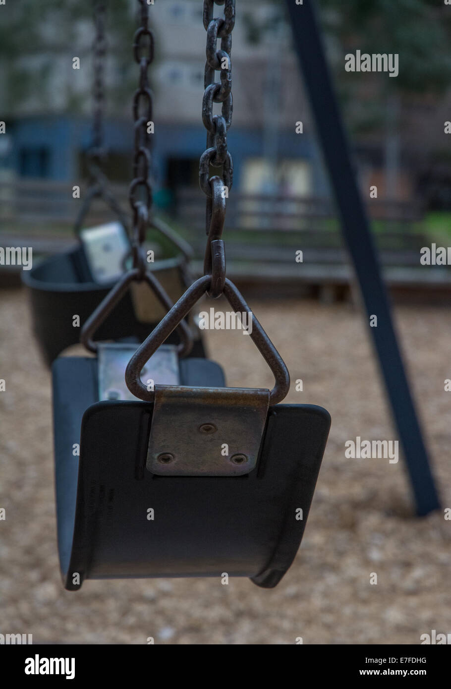 Close Up of empty swing seat in playground Stock Photo