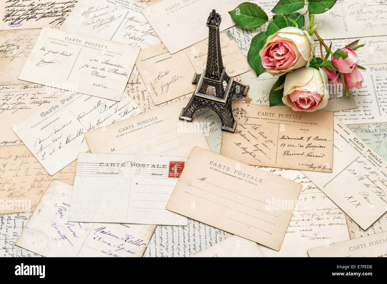 roses, antique french postcards carte postale and souvenir Eiffel Tower from Paris. nostalgic sentimental holidays background Stock Photo