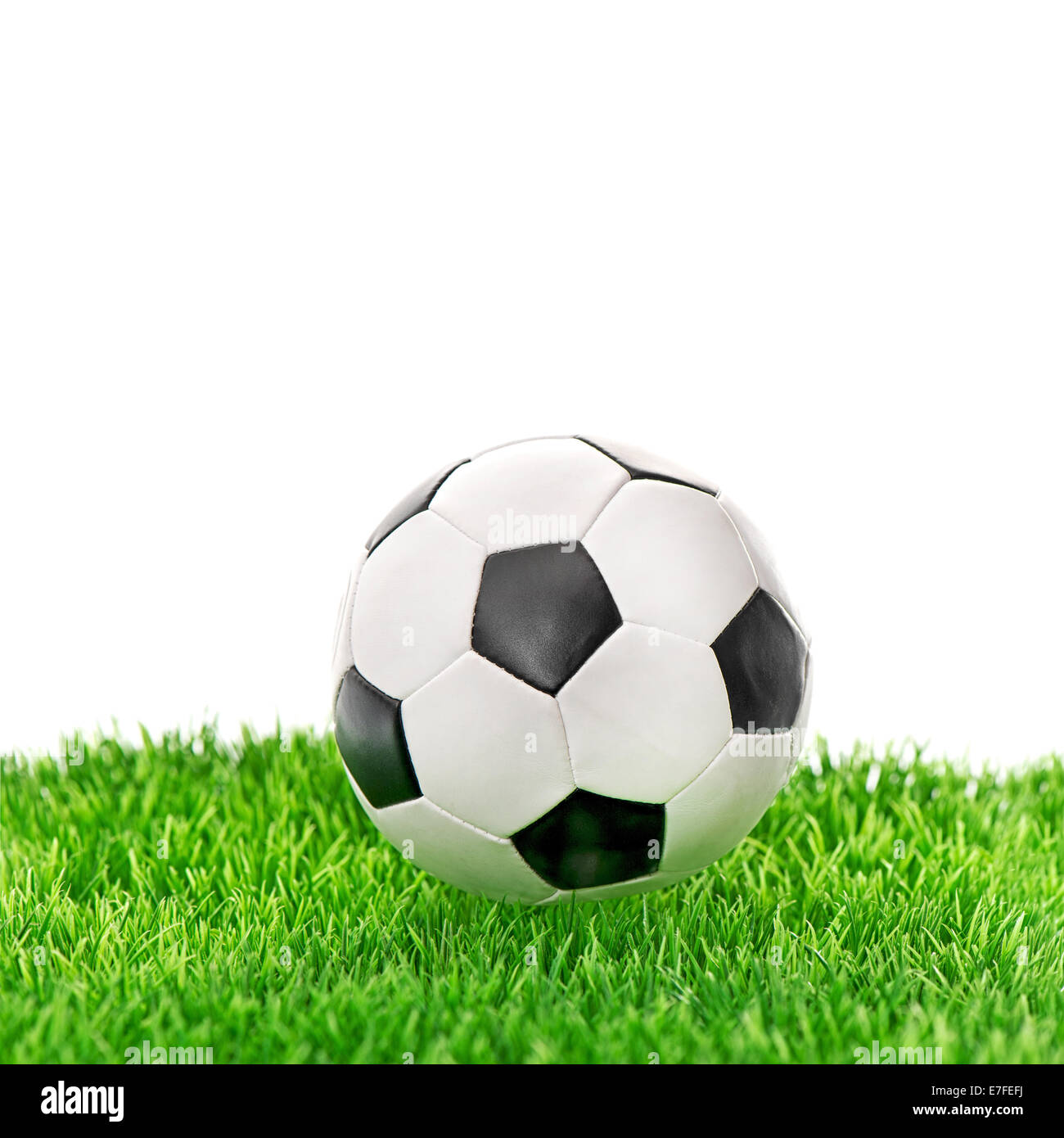soccer ball on green grass over white background Stock Photo