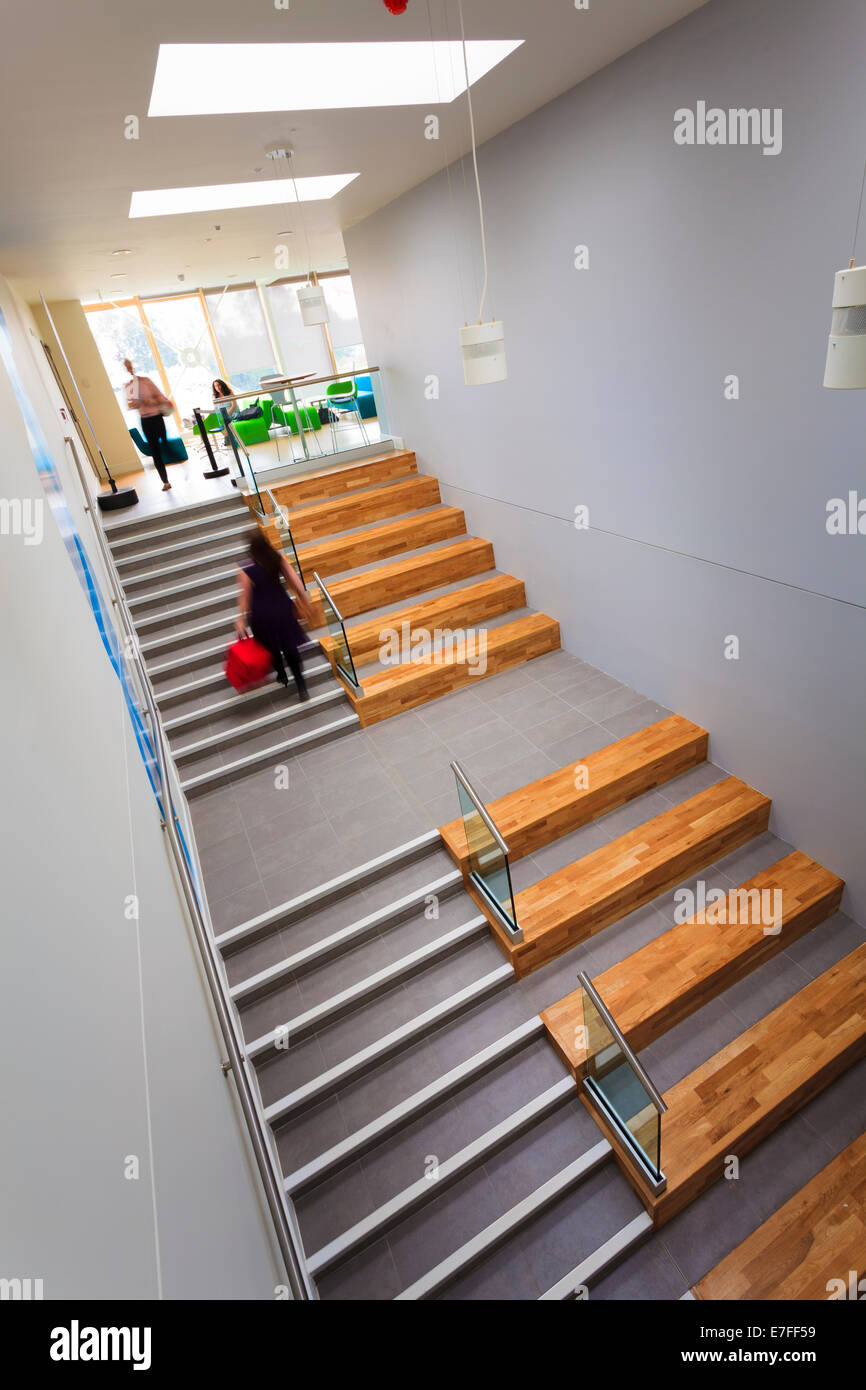 Blurred people walking up modern staircase. Stock Photo