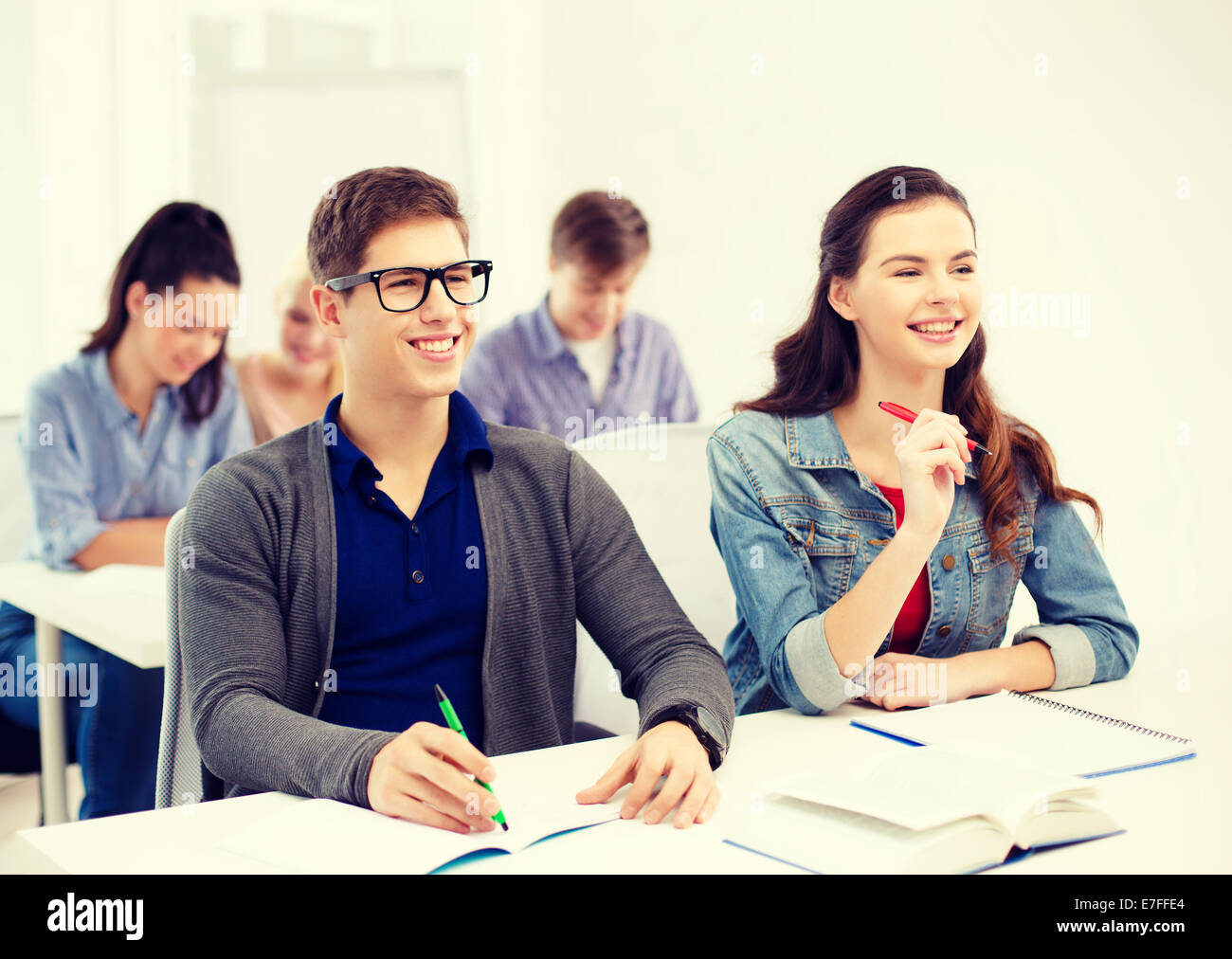 smiling students with notebooks at school Stock Photo - Alamy