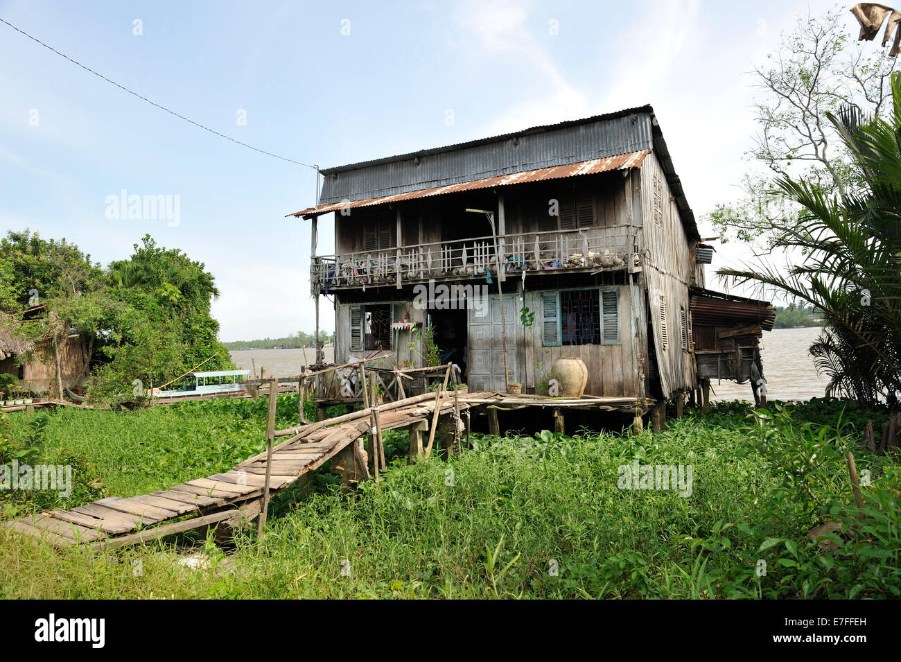 Wooden house on banks of Mekong River, Coconut Island (Con Phung), My Tho, Ben Tre province, Vietnam Stock Photo
