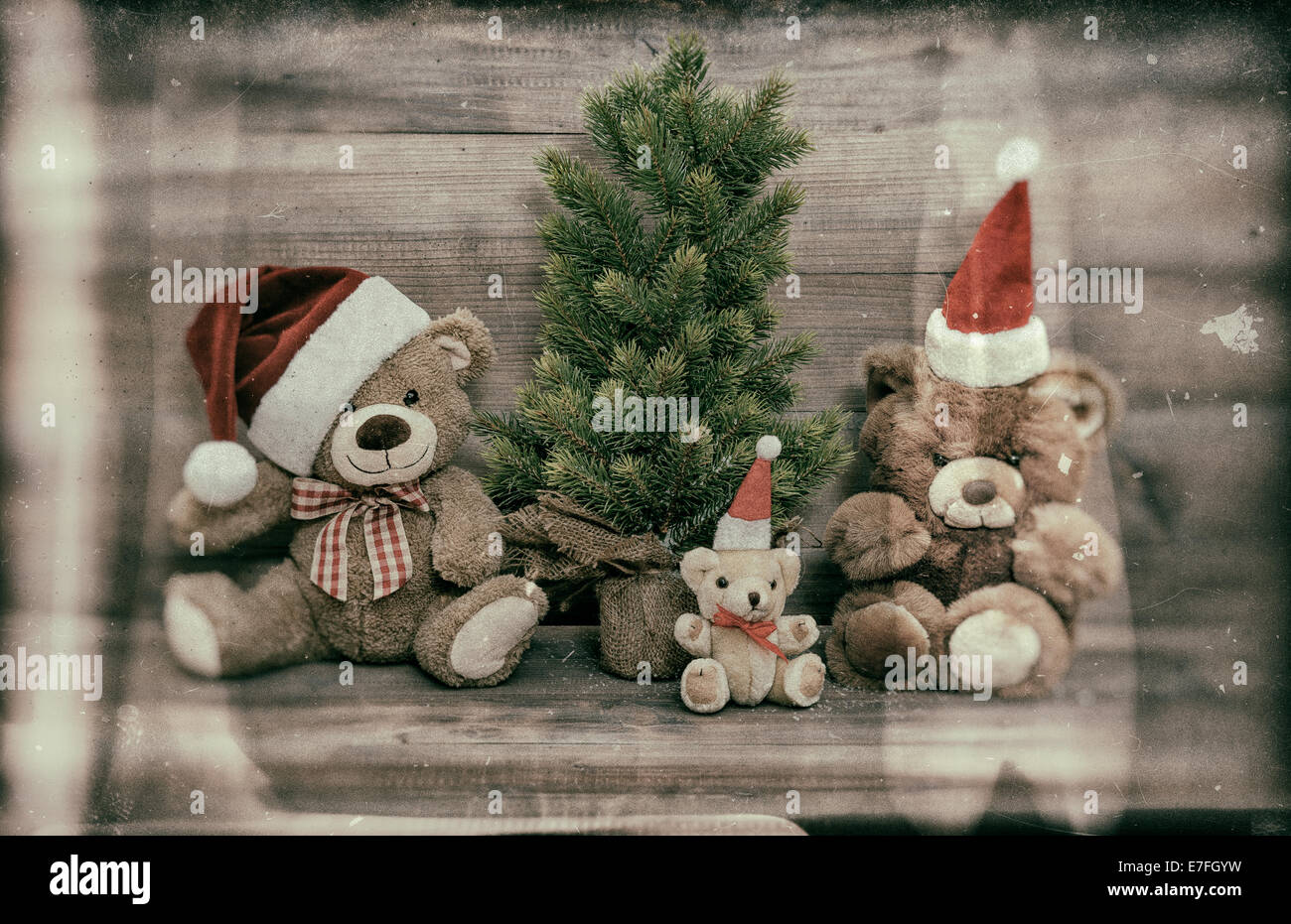 nostalgic christmas decoration with antique toys teddy bear family. retro style home interior. vintage style toned picture Stock Photo
