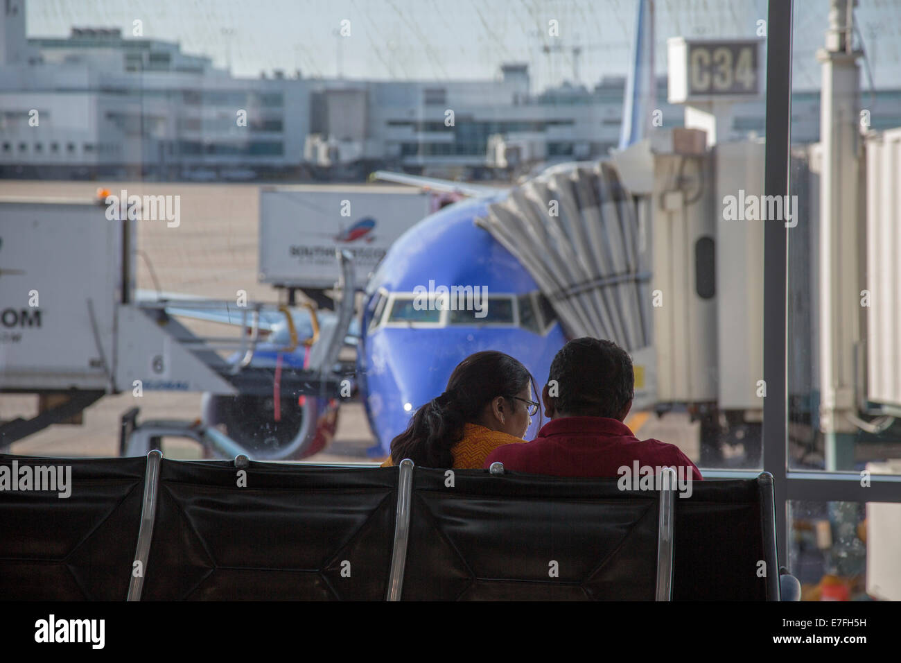 Denver, Colorado A couple waits for their flight at Denver