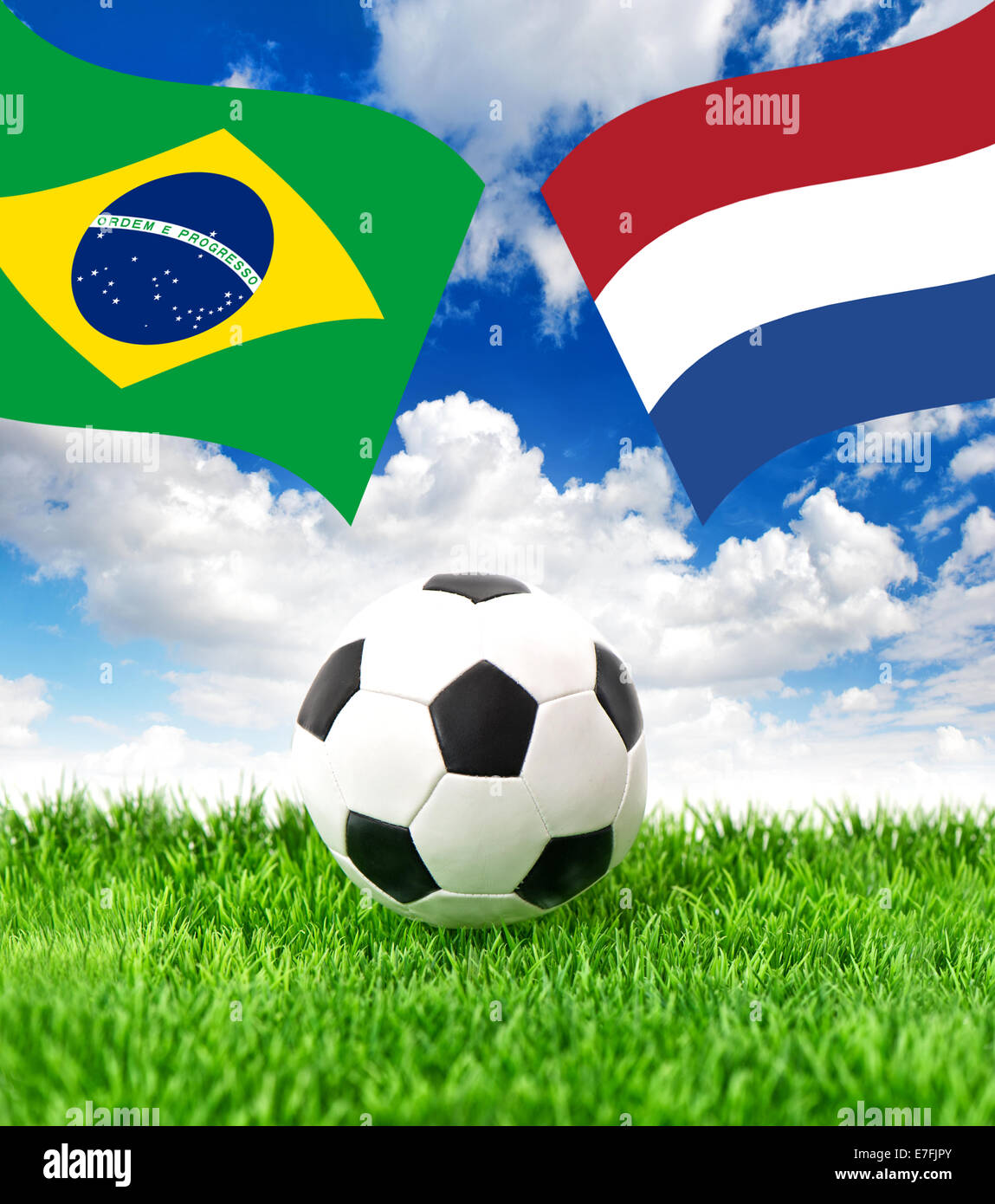 Soccer ball on green grass and national flags of Brazil and Netherlands over dramatic blue sky. Collage Stock Photo
