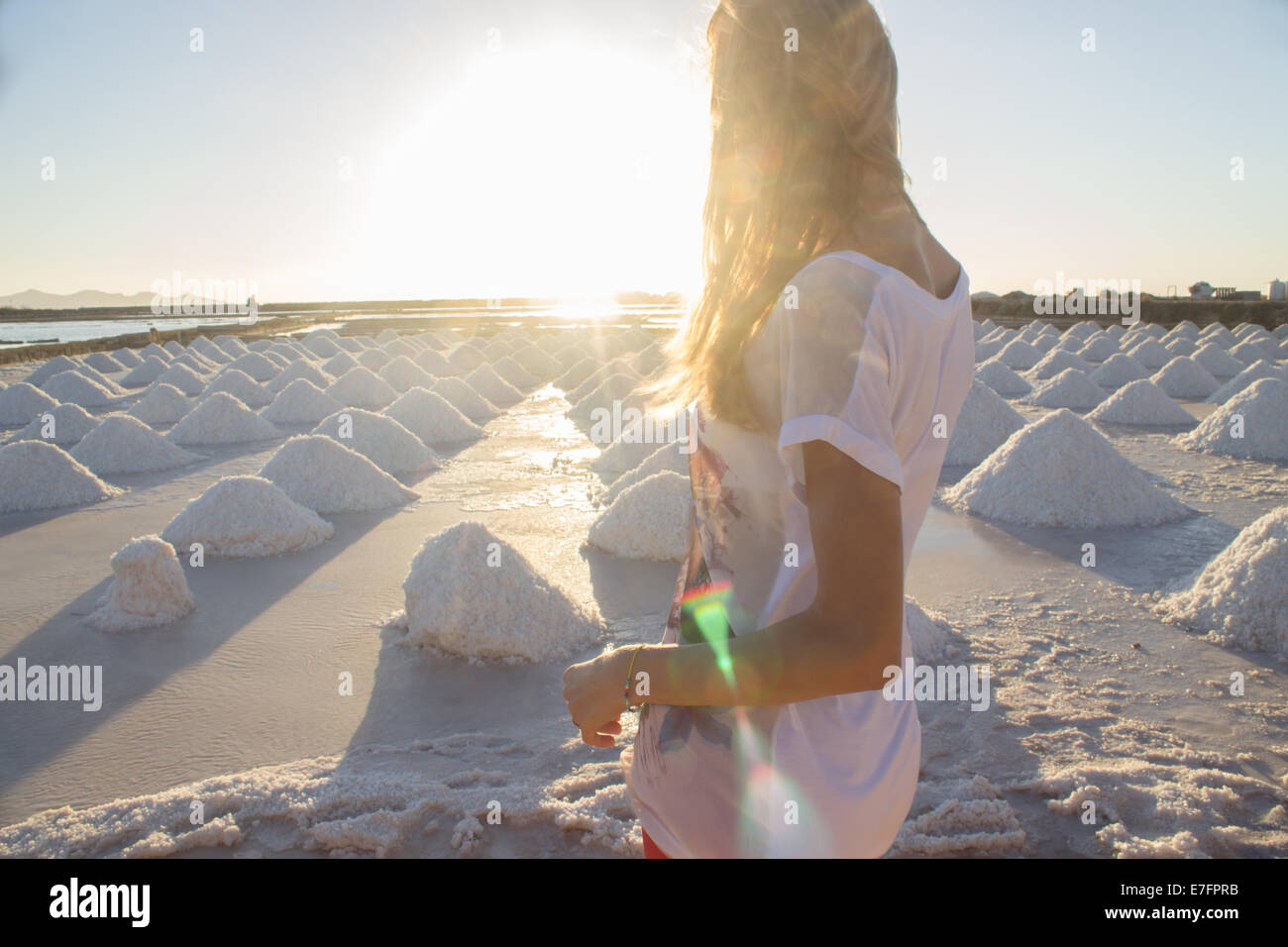 woman enjoying relaxing 'sea salt' 'salt marsh' landscape sunset sun 'salt mounds' nature horizontal horizon Stock Photo