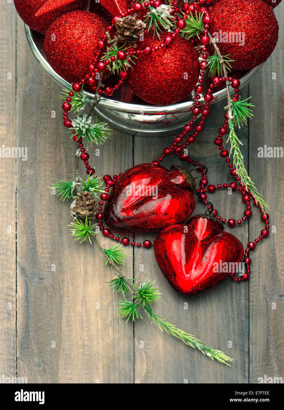 vintage christmas background with red baubles and hearts. festive decoration Stock Photo