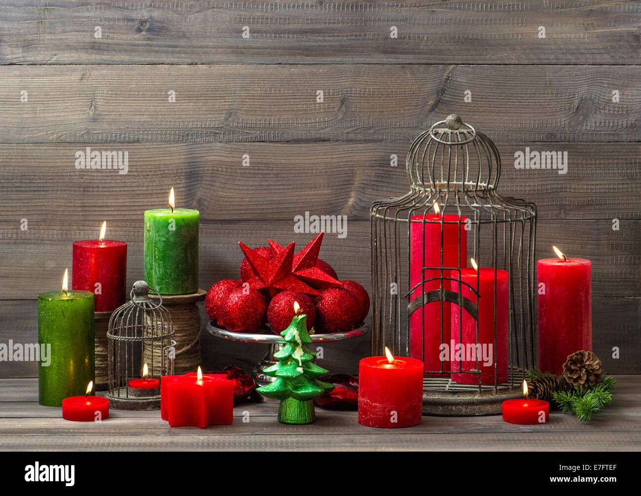 christmas decoration with burning candles, baubles and birdcage. nostalgic home interior Stock Photo