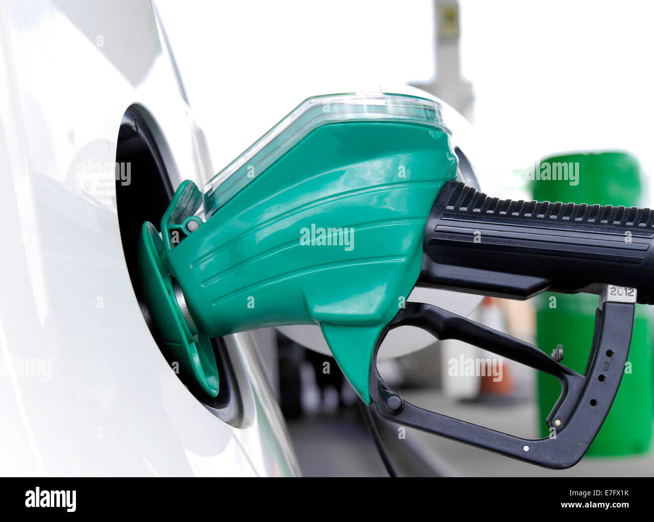 Closeup of petrol pump handle filling car with fuel Stock Photo
