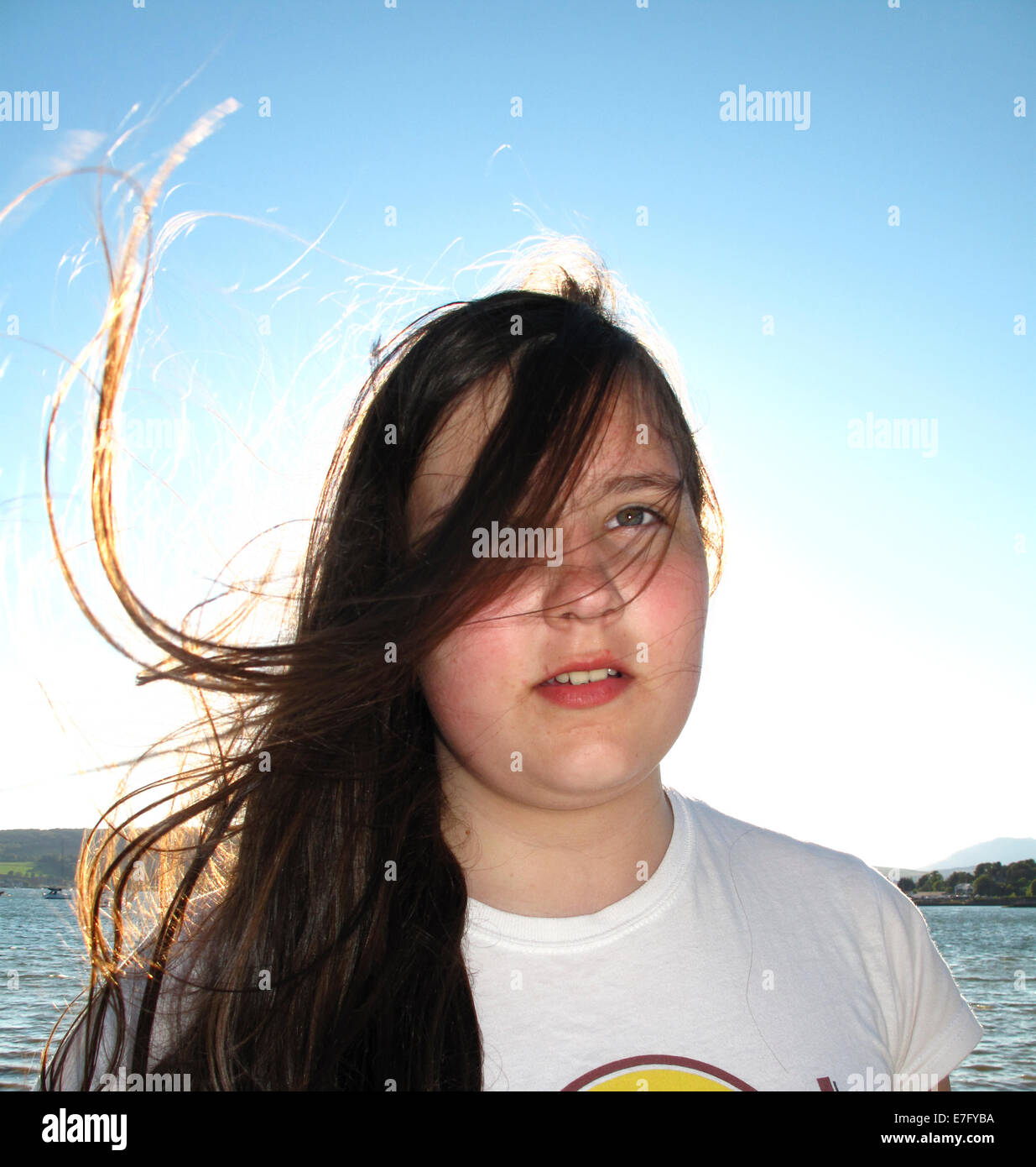 Young girl posing in sunshine backlit sidelit Stock Photo