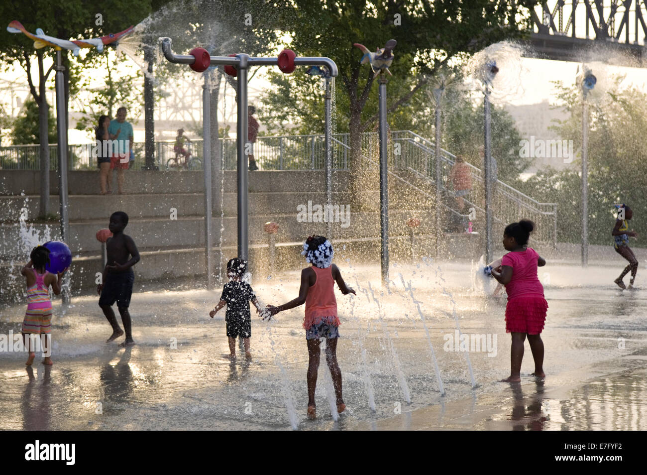 Children Playing in the Water Features on the Playground at Waterfront Park in Louisville Kentucky Stock Photo