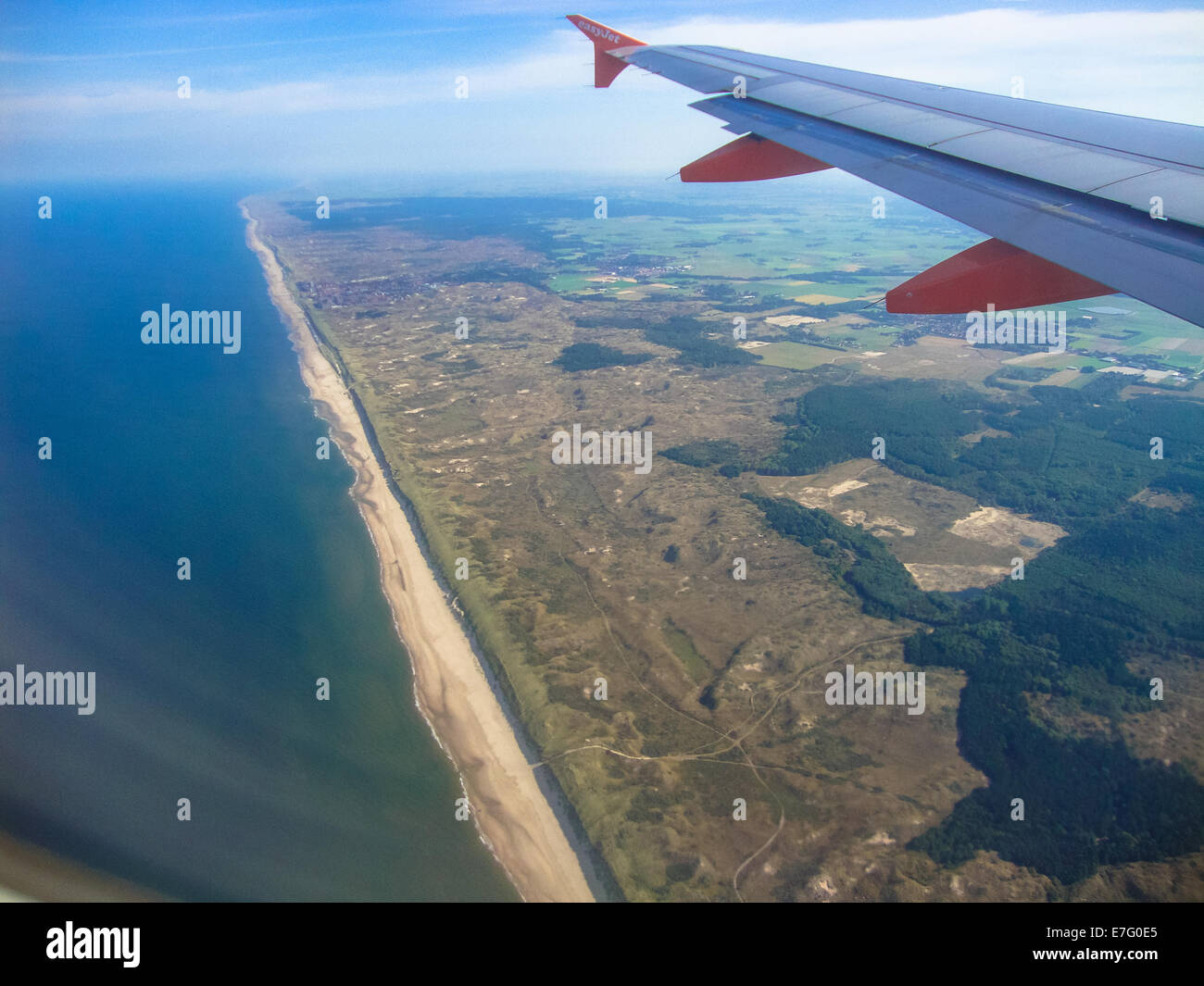 view from airplane at the coast of holland with part of the wing Stock ...