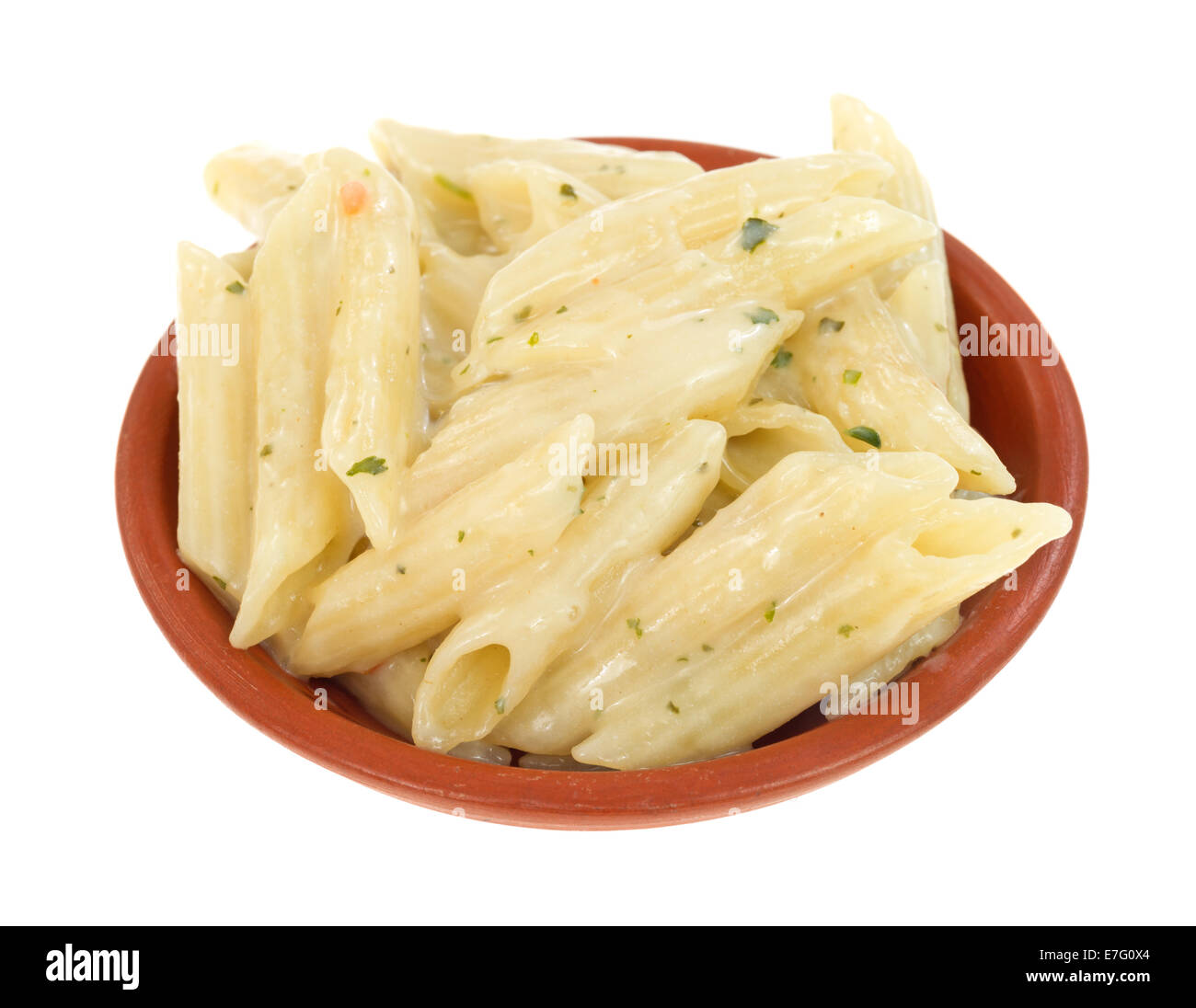 A small side dish of cooked pasta with garlic and parsley in a thick cream sauce on a white background. Stock Photo