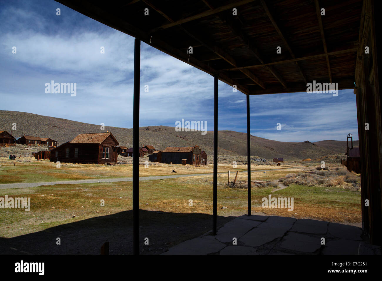 Old buildings seen from under the verandah of the Wheaten and Hollis Hotel, Bodie Ghost Town, Eastern Sierra, California, USA Stock Photo
