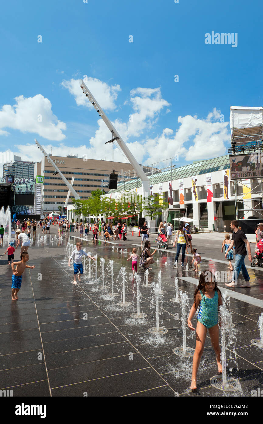 Children enjoying the fountains on Place des Festivals, Montreal, province of Quebec, Canada. Stock Photo