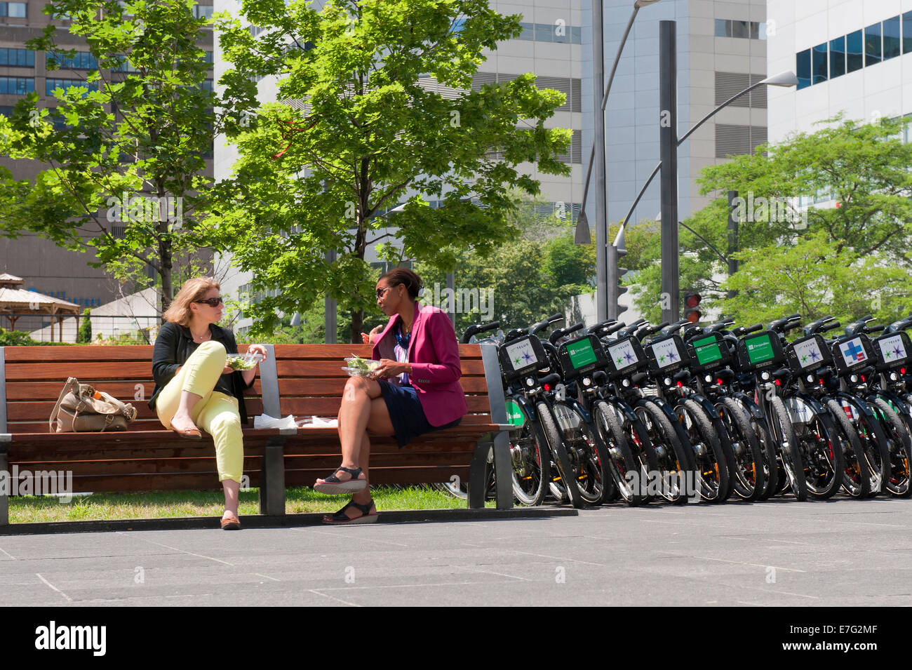 Office workers having lunch outdoors on Victoria Square, Montreal