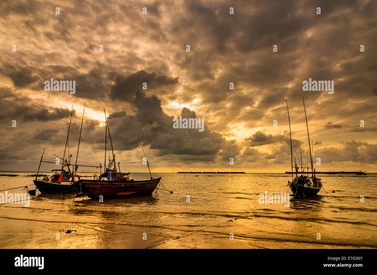 Fishing sea boat and Sunrise clouds before strom in Thailand blue light  tone Stock Photo - Alamy