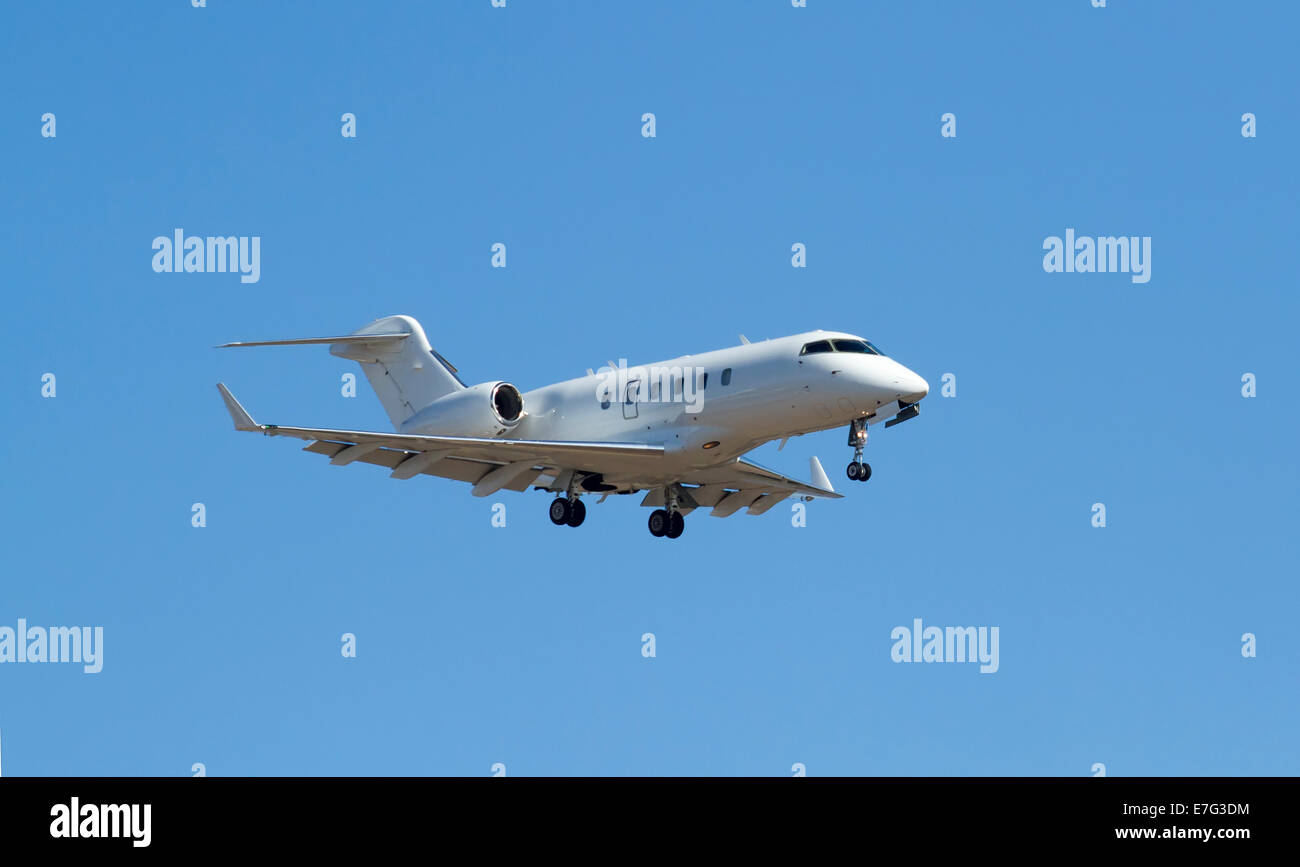 Private jet on landing approach with landing gear down Stock Photo