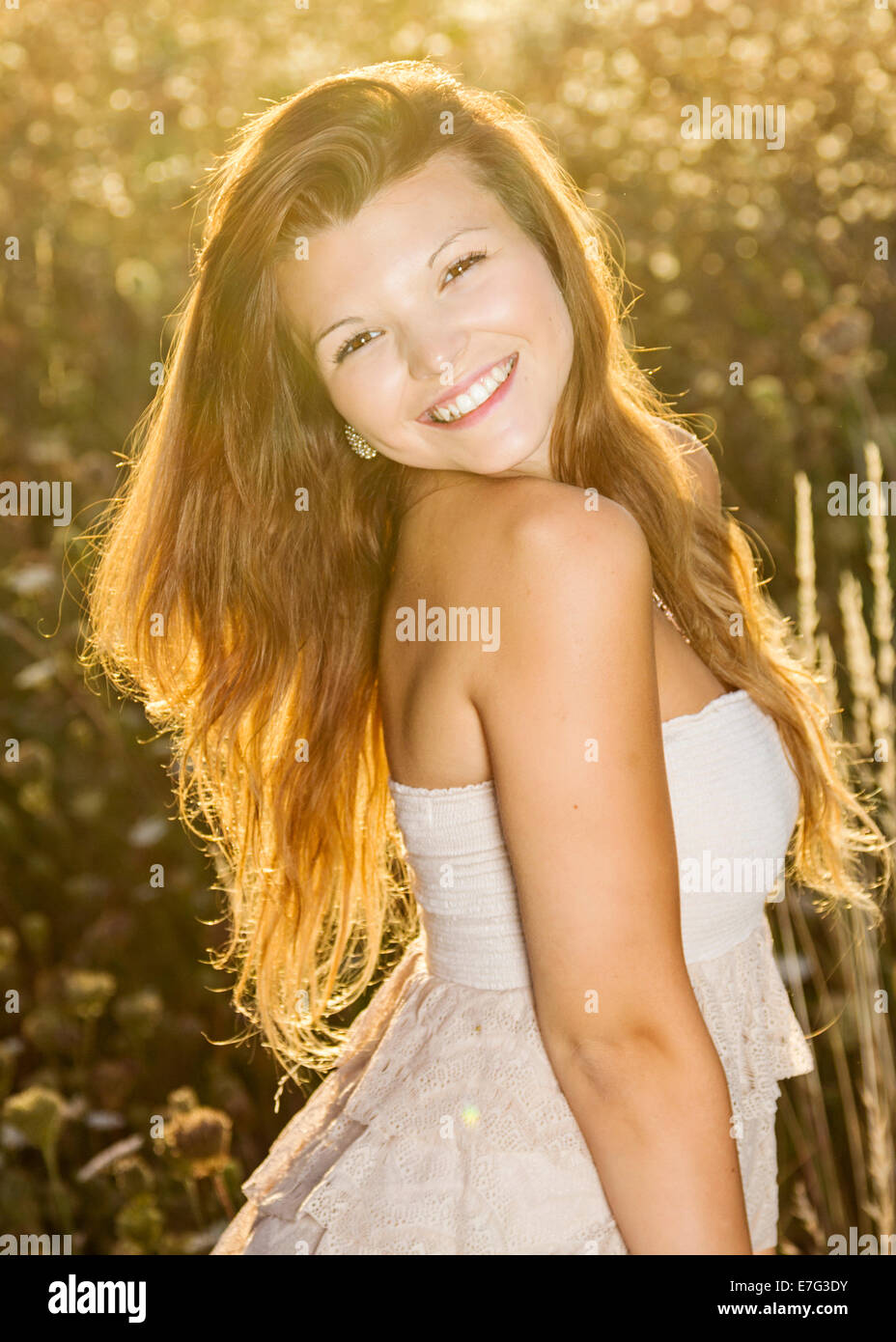 Portrait of a beautiful young woman in golden summer light Stock Photo