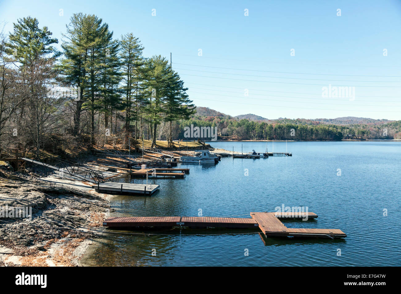 Wooden floating docks and boats along the shore of Lake Glenville near Cashiers, North Carolina on an autumn afternoon. Stock Photo