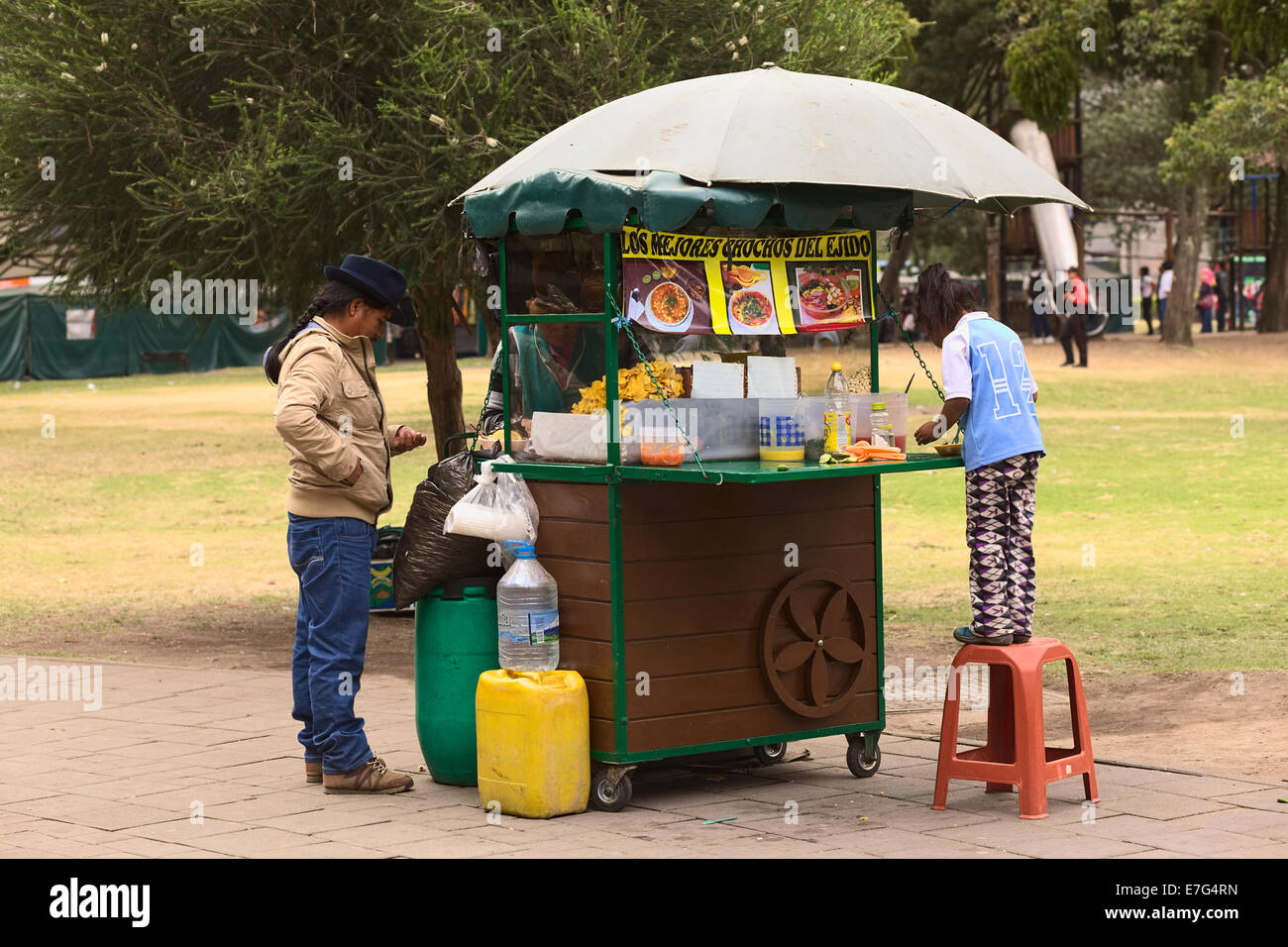 Unidentified people at snack stand selling chochos (white beans) in El Ejido Park in Quito, Ecuador Stock Photo