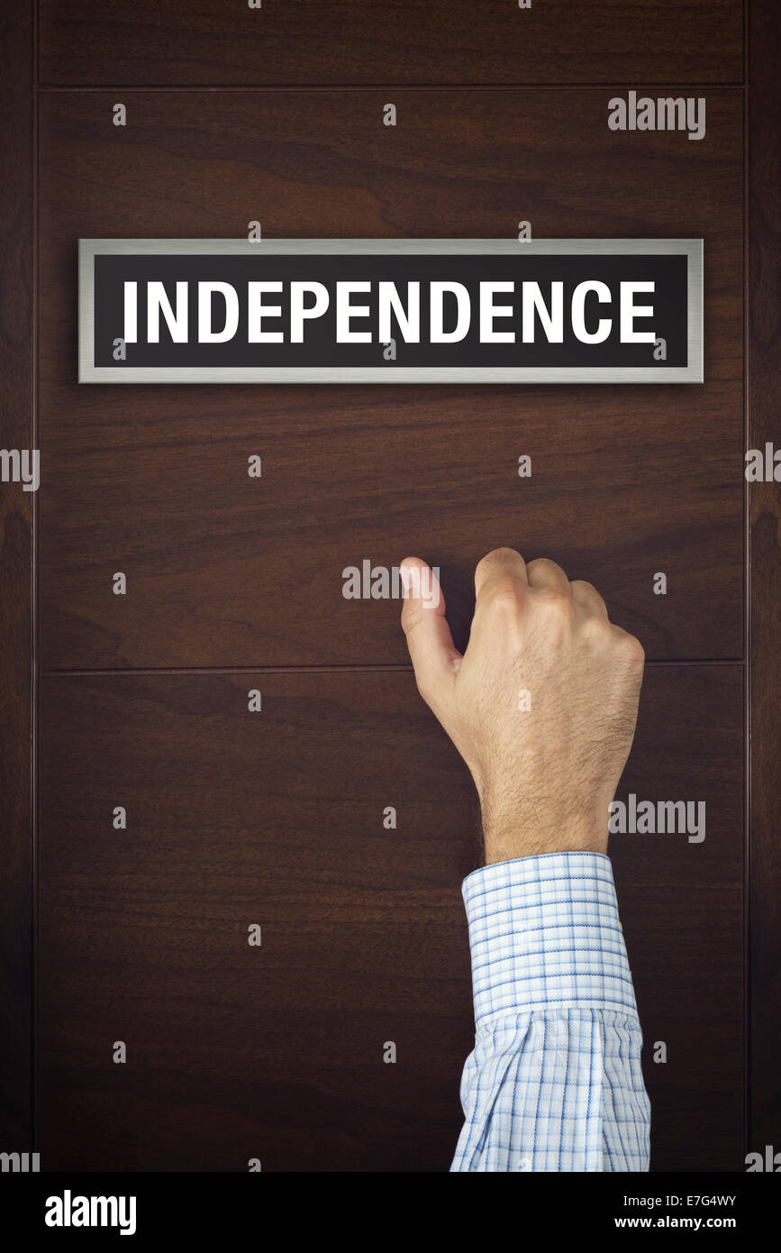Male hand is knocking on Independence door, conceptual image. Stock Photo