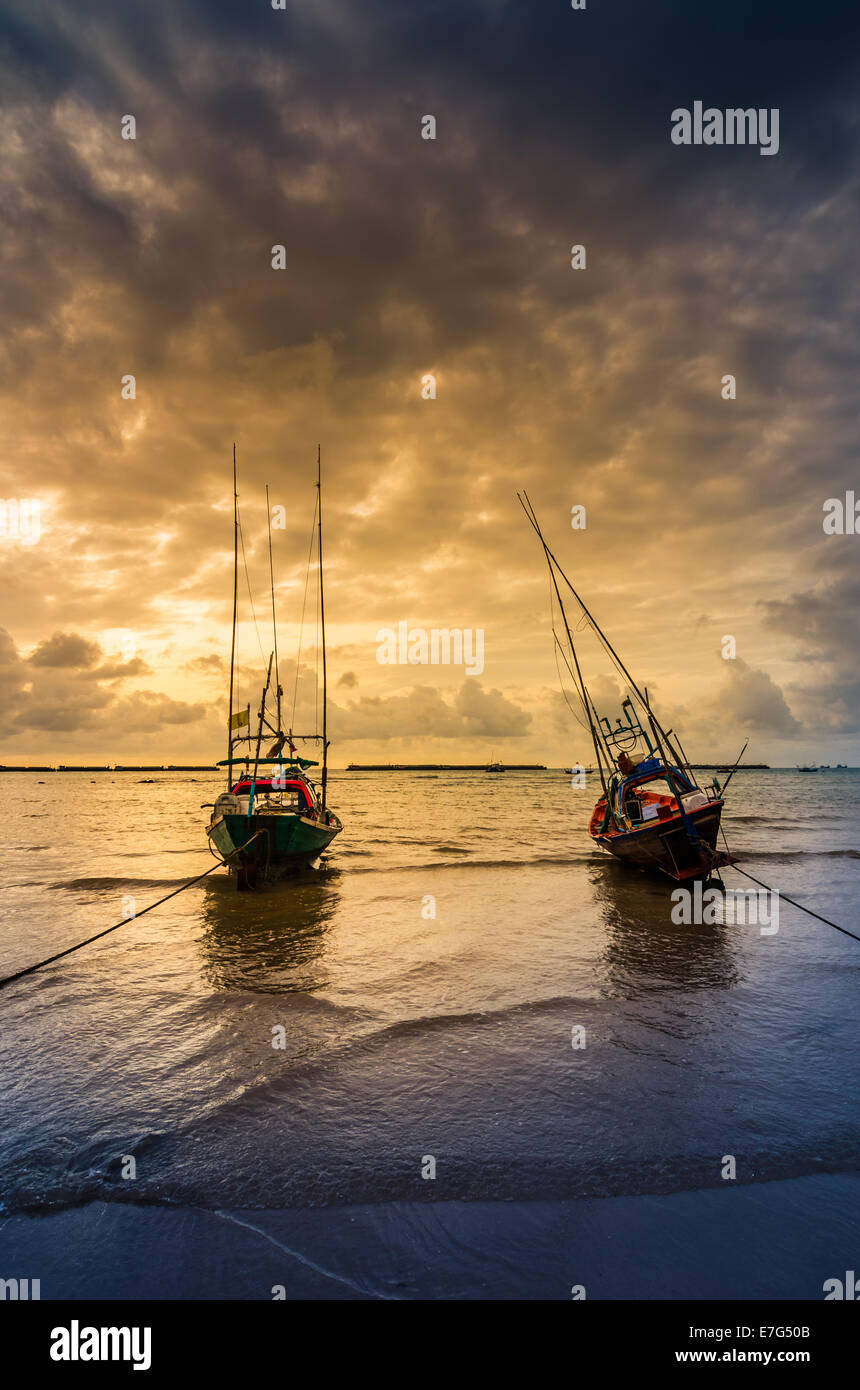 Fishing sea boat and Sunrise clouds before strom in Thailand blue light  tone Stock Photo - Alamy