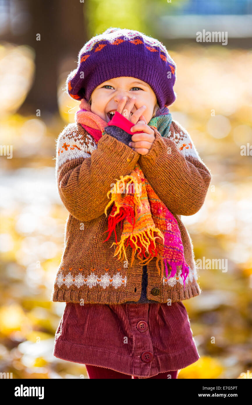 Happy little girl playing in the autumn park Stock Photo - Alamy